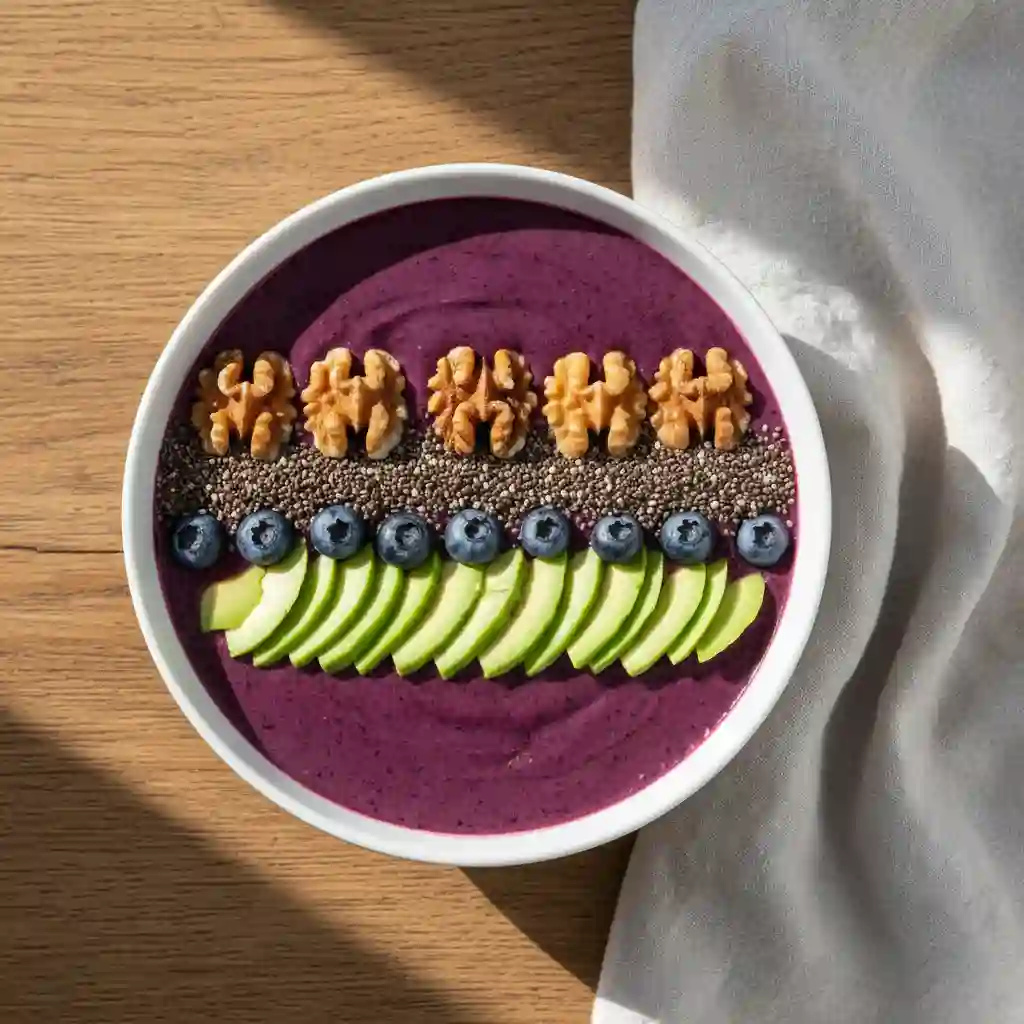 A top-down view of a purple blueberry smoothie bowl topped with walnuts and chia seeds on a wooden table, representing nutrition for mental health.