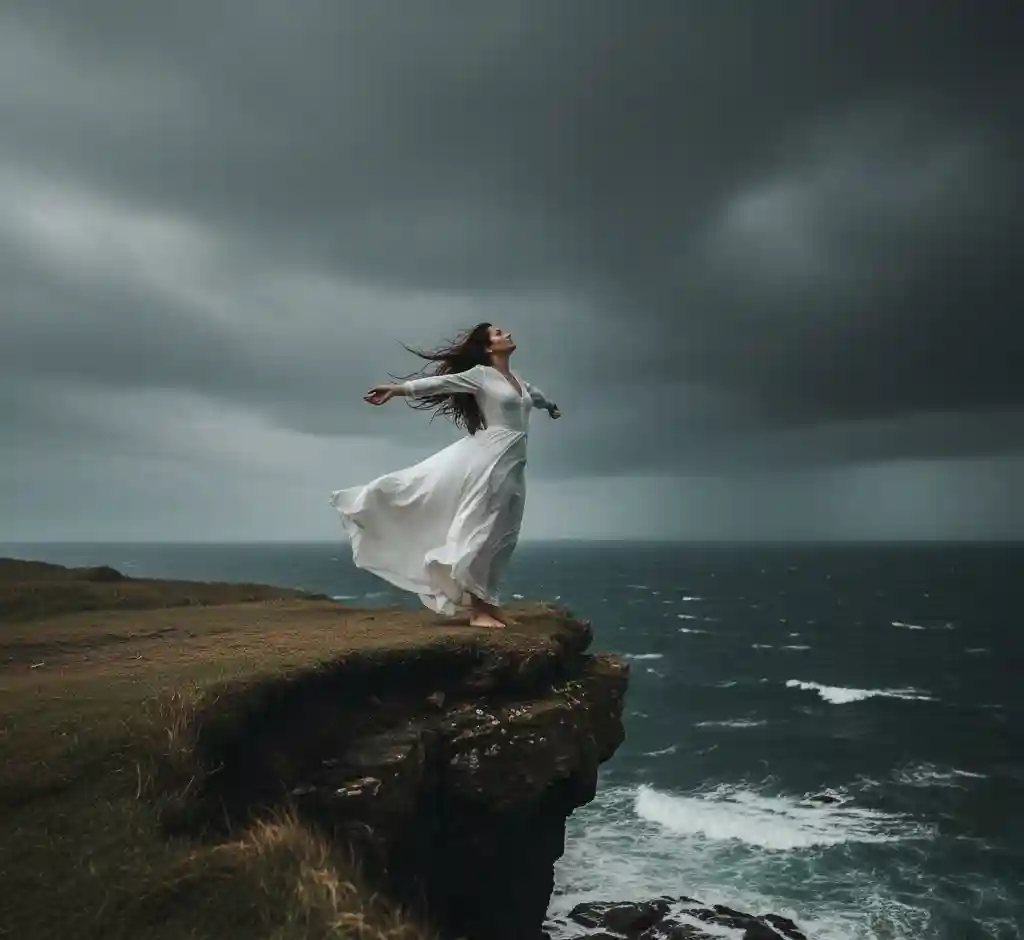 A woman standing on a cliff or open field with wind blowing her hair, arms open, symbolizing the freedom and change of angel number 555.